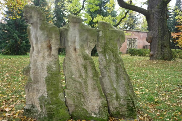 Steinskulptur auf einer Wiese, Wetterseiten mit Moos bewachsen